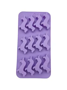 Macro view of purple silicone mold with 12 dachshund dog shaped cavities for baking and DIY