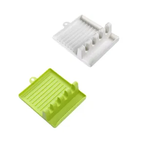 Multi-slot kitchen utensil rest and spoon holder for convenient countertop organization.