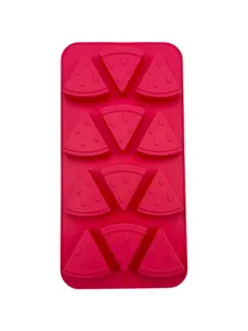 Top-down detail of red silicone mold with watermelon slice cavities