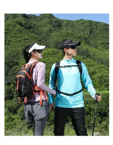 Active couple using breathable hiking backpacks on a scenic mountain trail