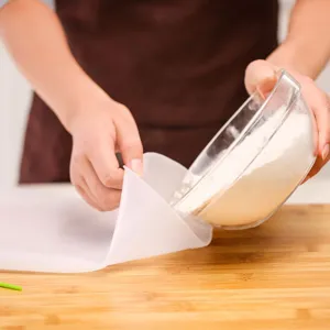 Food-grade silicone kneading bag for dough preparation on a natural wooden board