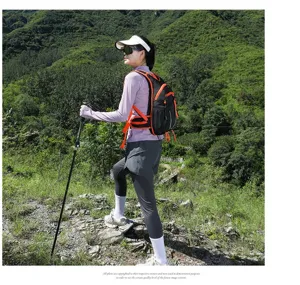 Outdoor enthusiast using a breathable marathon backpack while hiking in the mountains