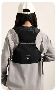 Back view of a lightweight black running vest backpack with reflective strips