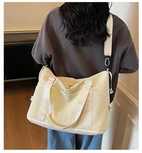 Large capacity cream multifunctional sports bag shown being worn as a shoulder bag