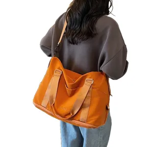 Large orange waterproof fitness bag for sports and travel with shoulder strap