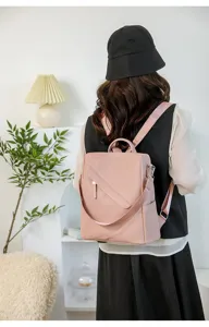 Stylish pink leather backpack detail showing anti-theft design and comfortable shoulder straps.