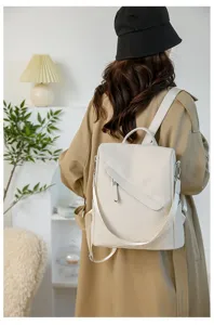 Detailed view of women's casual leather backpack, stylish daily wear on model, white color.