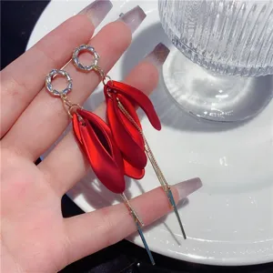 Close-up of long tassel earrings with red matte petals and micro-inlaid zircons.
