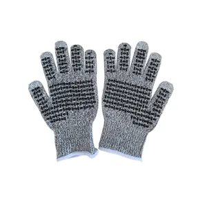 Detail macro view of gray cut-resistant work gloves with black anti-slip dot coating