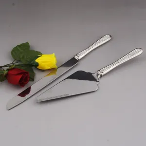 Close-up of stainless steel cake knife and server set with rhinestone handles