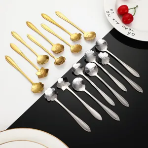 Stainless steel flower spoon detail view, elegant gold and silver floral coffee spoons close-up.