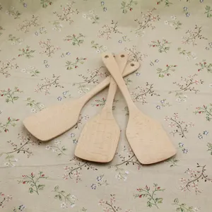Detailed view showing the natural grain of three beech wood spatulas for kitchen cooking