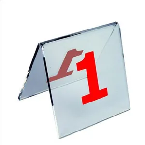 Detailed view of a V-shaped clear acrylic desk number plate with a bold red number one