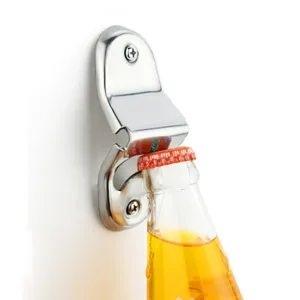 Action shot of a stainless steel wall-mounted bottle opener prying open a glass soda bottle.