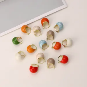 Macro view of vintage drip glaze hoop earrings in various vibrant fashion colors.