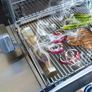 Vista detallada de un tubo ahumador de acero inoxidable soltando humo denso en una parrilla