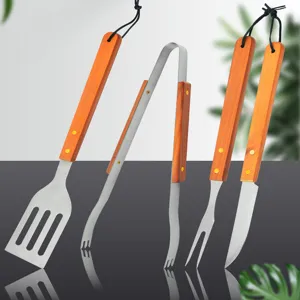 Detailed view of 4-piece stainless steel BBQ tool set with wooden handles