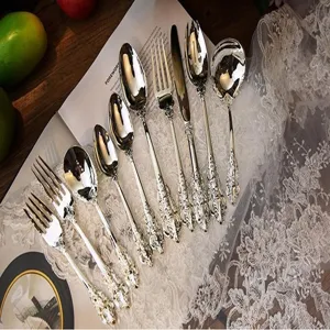 Close-up of vintage royal silver-plated cutlery set with ornate engraved handles