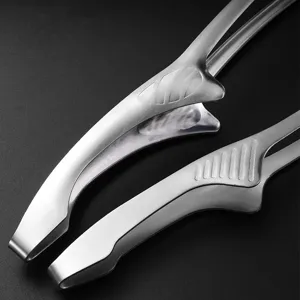 Macro detail of brushed stainless steel BBQ tongs showing non-slip texture.