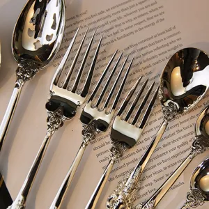 Detailed macro view of vintage silver-plated cutlery with ornate royal court style engraving