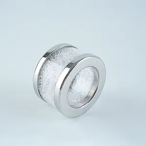 Detailed shot of a sleek silver metal crystal napkin ring, sparkling rhinestone tableware.