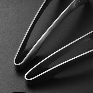 Macro detail of professional stainless steel food tongs with a brushed metal finish.