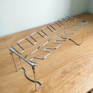 Close-up of a stainless steel foldable chicken leg rack for outdoor BBQ grilling