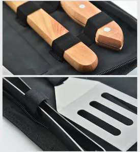 Detailed close-up view of stainless steel BBQ tools with smooth wooden handles in case