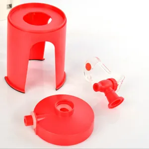 Detail view showing red plastic parts and clear faucet of an inverted soda dispenser