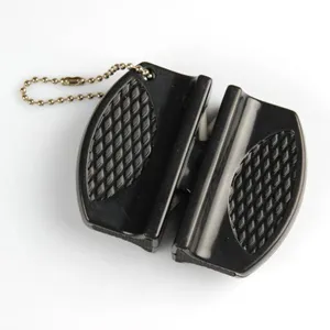 Close-up view of portable mini knife sharpener with black diamond textured grip