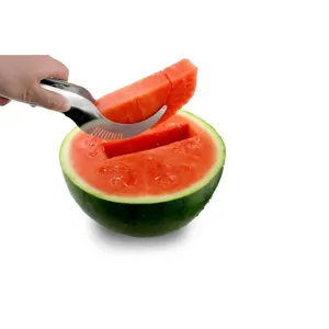 Close-up of a stainless steel slicer cutting and lifting a fresh watermelon slice