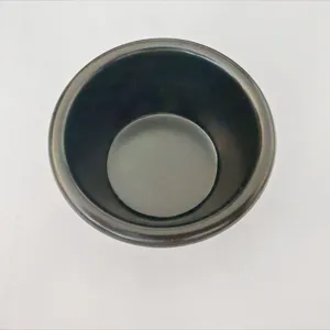 High-angle macro detail shot of a minimalist black sauce bowl for condiments and dips