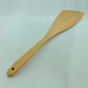 Close-up of a beech wood spatula with natural grain and a hanging hole