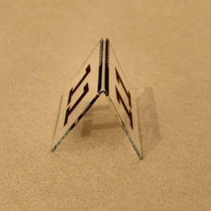 Detail showing a transparent V-shaped acrylic table number sign with black printed number 11