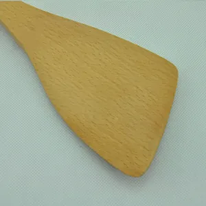 Detailed close-up showing the smooth natural grain of a beech wood cooking spatula