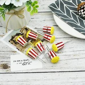 Detail of popcorn bucket shaped corn holders with stainless steel twin tines