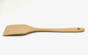 Macro detail of a beechwood kitchen spatula for non-stick pans on a white background