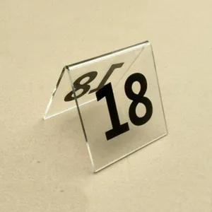 Detailed view of clear acrylic V-shaped table number plate with bold black digit