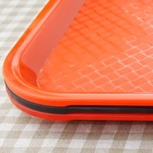 Close-up detail of rectangular plastic fast food tray with anti-slip surface texture.