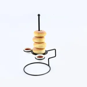 Creative black metal stand for displaying donuts or onion rings with two sauce cups