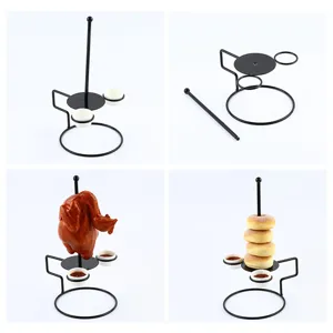 Detail view of black metal food tower rack showing assembly and creative serving for donuts