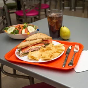 Orange rectangular plastic cafeteria tray detail, durable food serving plate for restaurant canteen.