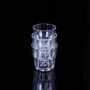Macro detail showing stacked clear octagonal acrylic glasses on black background