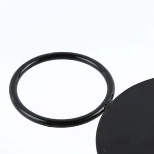 Macro view of the smooth black metal ring handle on the creative food display stand