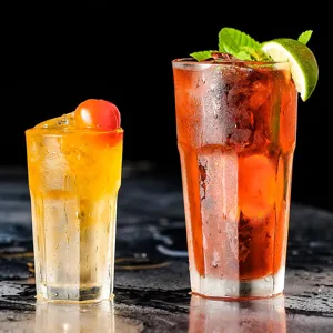 Detail shot of octagonal acrylic cups filled with refreshing cold drinks and garnishes