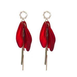 Detailed view of elegant long red petal earrings with sparkling zircon and gold tassels