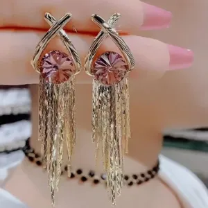 Elegant golden long tassel earrings featuring a faceted round pink stone in Korean style