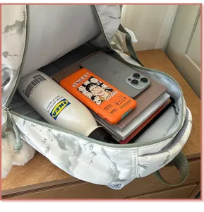 Detailed internal view showing the large storage capacity of the minimalist student backpack.