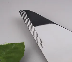 Detailed macro close-up of the sharp serrated edge of this stainless steel cake knife and server