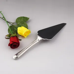 Detailed view of a polished stainless steel cake server with artificial roses decoration